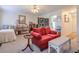 Cozy living room featuring a comfortable red sofa, decorative screen, and a ceiling fan at 2937 Torreya Way, Marietta, GA 30067