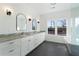 Bathroom featuring double vanity with grey countertops and a soaking tub at 364 Poplar Springs Rd, Hiram, GA 30141