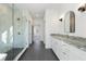 Bathroom featuring tiled shower, double vanity with grey counters, and grey tile flooring at 364 Poplar Springs Rd, Hiram, GA 30141