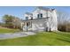 Inviting two-story home showcases a charming front porch, a two car garage, and a concrete driveway on a green lawn at 364 Poplar Springs Rd, Hiram, GA 30141