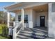 The inviting front porch features a stylish railing and a stained wood ceiling, adding architectural interest and curb appeal at 364 Poplar Springs Rd, Hiram, GA 30141