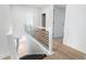 Upstairs hallway features hardwood floors and a modern banister at 364 Poplar Springs Rd, Hiram, GA 30141