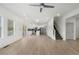 Open-concept living space with hardwood floors, leading into a modern kitchen with stainless steel appliances and a kitchen island at 364 Poplar Springs Rd, Hiram, GA 30141
