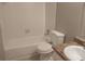 Tidy bathroom with a shower-tub combo, white tile, and vanity, providing a functional space at 4952 Isle Royal Ct, Stone Mountain, GA 30088
