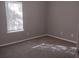 Bright bedroom featuring fresh paint, carpet, and a window that allows natural light to flood the space at 4952 Isle Royal Ct, Stone Mountain, GA 30088