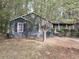 A charming house with a yard sits nestled among lush trees at 4952 Isle Royal Ct, Stone Mountain, GA 30088