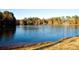 Scenic view of the lake surrounded by lush greenery and trees in a quiet neighborhood at 4952 Isle Royal Ct, Stone Mountain, GA 30088