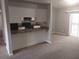 Open-concept living space featuring carpet flooring, a breakfast bar, and sliding glass door access to the outside at 4952 Isle Royal Ct, Stone Mountain, GA 30088