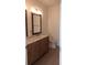 Bright bathroom featuring a double vanity, large mirror, and toilet at 8155 Stone Hill Rd, Cumming, GA 30028
