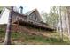 Charming home featuring a spacious deck, ideal for outdoor entertaining in a peaceful wooded setting at 8155 Stone Hill Rd, Cumming, GA 30028