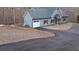 Newly constructed home with gray siding and a paved driveway at 8155 Stone Hill Rd, Cumming, GA 30028