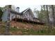 Charming home featuring a spacious deck, ideal for outdoor entertaining in a peaceful wooded setting at 8155 Stone Hill Rd, Cumming, GA 30028
