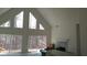Bright living room with a fireplace and large windows offering serene views at 8155 Stone Hill Rd, Cumming, GA 30028