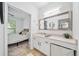 Bright bathroom sink and cabinet with a large mirror reflecting a bedroom at 821 Ralph Mcgill Ne Blvd # 3201, Atlanta, GA 30306