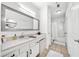 Bright bathroom featuring a large mirror, double lights, a bath tub and beige tile flooring at 821 Ralph Mcgill Ne Blvd # 3201, Atlanta, GA 30306