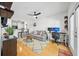 Bright living room featuring hardwood floors, a ceiling fan, and a comfortable couch with a workspace at 821 Ralph Mcgill Ne Blvd # 3201, Atlanta, GA 30306