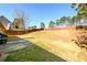 Large backyard enclosed by a privacy fence, offering ample space for activities at 892 Creek Bottom Rd, Loganville, GA 30052