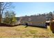 Large, level backyard enclosed by a wooden fence offers privacy and ample space for recreation at 892 Creek Bottom Rd, Loganville, GA 30052