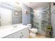 The renovated bathroom has a modern sink, toilet, and walk-in shower with glass doors at 892 Creek Bottom Rd, Loganville, GA 30052