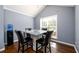 Bright dining area with square glass-top table, comfortable seating, and water cooler at 892 Creek Bottom Rd, Loganville, GA 30052