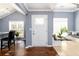 Welcoming entryway with wood floors, white door, and built-in bench seating at 892 Creek Bottom Rd, Loganville, GA 30052