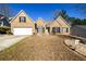 Charming single-story brick home with a two-car garage and a well-maintained lawn at 892 Creek Bottom Rd, Loganville, GA 30052