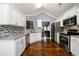Bright kitchen featuring stainless steel appliances, granite countertops, and mosaic tile backsplash at 892 Creek Bottom Rd, Loganville, GA 30052