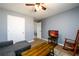 This living room features a comfortable couch and TV with views of the exterior at 892 Creek Bottom Rd, Loganville, GA 30052