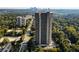 Striking high-rise apartment building surrounded by mature trees and skyline in the distance at 2660 Peachtree Nw Rd # 14D, Atlanta, GA 30305