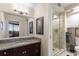 Bathroom featuring granite counters, updated lighting, and a glass shower with tile surround and bench at 2660 Peachtree Nw Rd # 14D, Atlanta, GA 30305