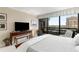 Neutral bedroom featuring a king size bed, large windows with great views, and a balcony at 2660 Peachtree Nw Rd # 14D, Atlanta, GA 30305