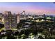 Beautiful city skyline views from a high-rise apartment surrounded by lush greenery and trees at 2660 Peachtree Nw Rd # 14D, Atlanta, GA 30305