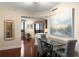 Stylish dining area with hardwood floors, modern lighting, and a view into the open kitchen at 2660 Peachtree Nw Rd # 14D, Atlanta, GA 30305