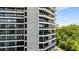 The exterior of the building showcasing balconies and the surrounding trees at 2660 Peachtree Nw Rd # 14D, Atlanta, GA 30305