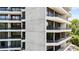 Exterior of the building featuring balconies with black railings and views of trees at 2660 Peachtree Nw Rd # 14D, Atlanta, GA 30305