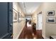 Elegant hallway with hardwood floors leading to a bright living space with outside views and neutral paint at 2660 Peachtree Nw Rd # 14D, Atlanta, GA 30305