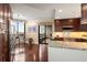 A modern kitchen featuring custom cabinets, stainless steel appliances, and granite counters with an adjacent dining area at 2660 Peachtree Nw Rd # 14D, Atlanta, GA 30305