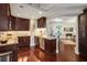 A kitchen with custom cabinets, granite countertops, stainless steel appliances, and dark hardwood flooring at 2660 Peachtree Nw Rd # 14D, Atlanta, GA 30305