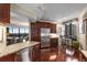 An open kitchen with stainless steel appliances, granite counters, a breakfast nook, and wood floors at 2660 Peachtree Nw Rd # 14D, Atlanta, GA 30305