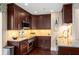 Modern kitchen with stainless steel appliances, granite countertops, and dark wood cabinetry at 2660 Peachtree Nw Rd # 14D, Atlanta, GA 30305