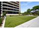 A view of the building's exterior and manicured green space with seating and landscaping at 2660 Peachtree Nw Rd # 14D, Atlanta, GA 30305