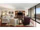 Comfortable living room with a large window, plush seating, and a built-in entertainment center at 2660 Peachtree Nw Rd # 14D, Atlanta, GA 30305