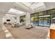 Stylish lounge area featuring modern lighting, comfortable seating, and floor-to-ceiling windows with a pool view at 2660 Peachtree Nw Rd # 14D, Atlanta, GA 30305