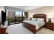 Spacious main bedroom boasts a king size bed, balcony access, large windows, and city views at 2660 Peachtree Nw Rd # 14D, Atlanta, GA 30305