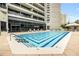 Beautiful pool area with lounge seating, surrounded by lush landscaping and shade at 2660 Peachtree Nw Rd # 14D, Atlanta, GA 30305