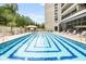 Inviting pool featuring geometric design with lounge chairs, palm trees, and manicured landscaping at 2660 Peachtree Nw Rd # 14D, Atlanta, GA 30305