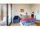 Cozy bedroom with a modern dresser, comfortable seating area, and a sliding glass door to the outside at 112 Rogers St # 409, Atlanta, GA 30317