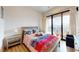 Bright bedroom featuring a comfortable bed, sliding glass door to the outside, and modern furnishings at 112 Rogers St # 409, Atlanta, GA 30317