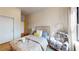 Comfortable bedroom with a patterned bedspread, side table, and window at 112 Rogers St # 409, Atlanta, GA 30317