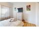 Cozy bedroom with a light colored dresser, a TV, and modern décor at 112 Rogers St # 409, Atlanta, GA 30317